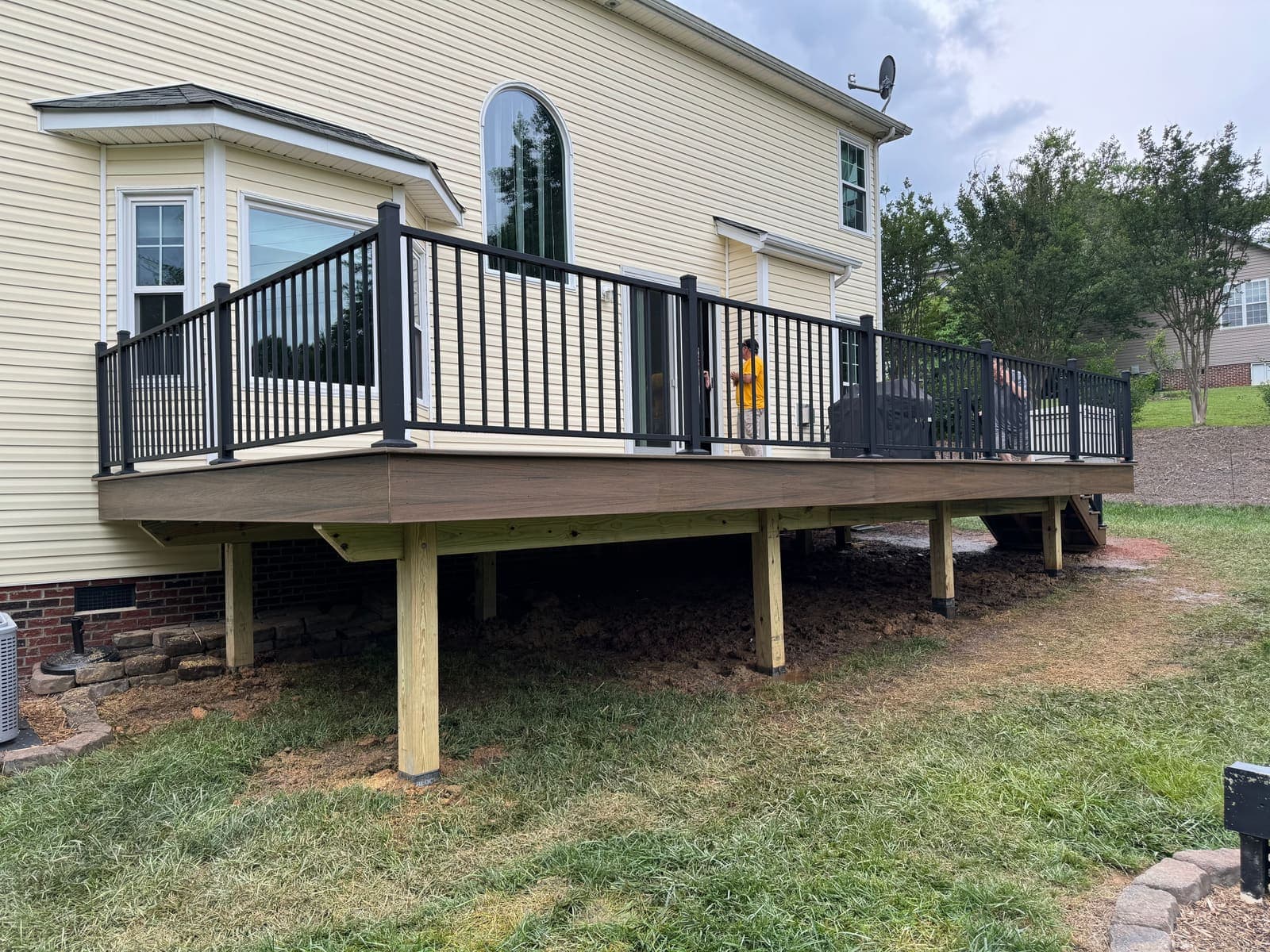 A picturesque deck with various railing options, showcasing cable, aluminum, composite, and glass styles.