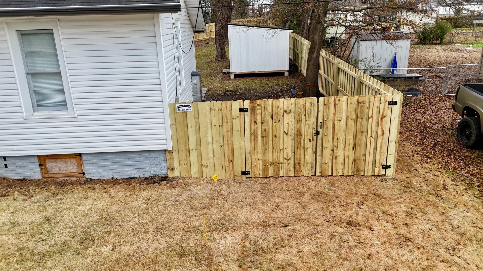 A well-built wooden fence in a residential yard in Rock Hill, SC.